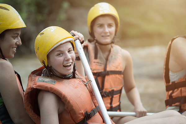 girl smiling while white water rafting