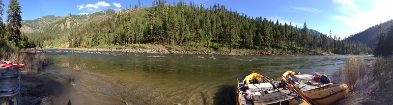 Wide river image with rafts on the shoreline